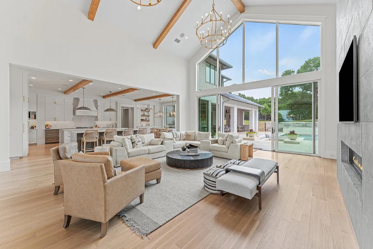 Living room with hardwood floors, couches and a fireplace.