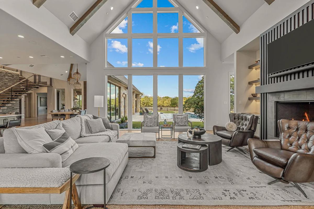 Living room with glass walls and a fireplace.