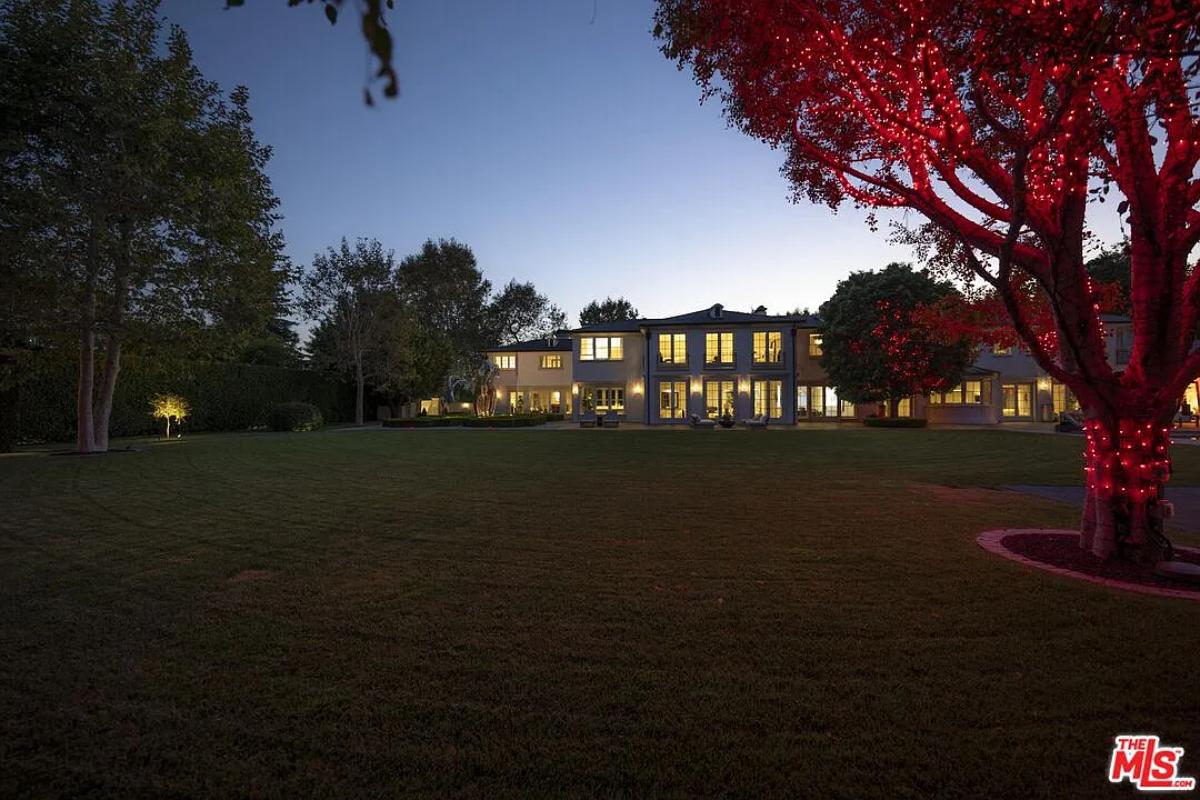 Rear view of the mansion with a large lawn.