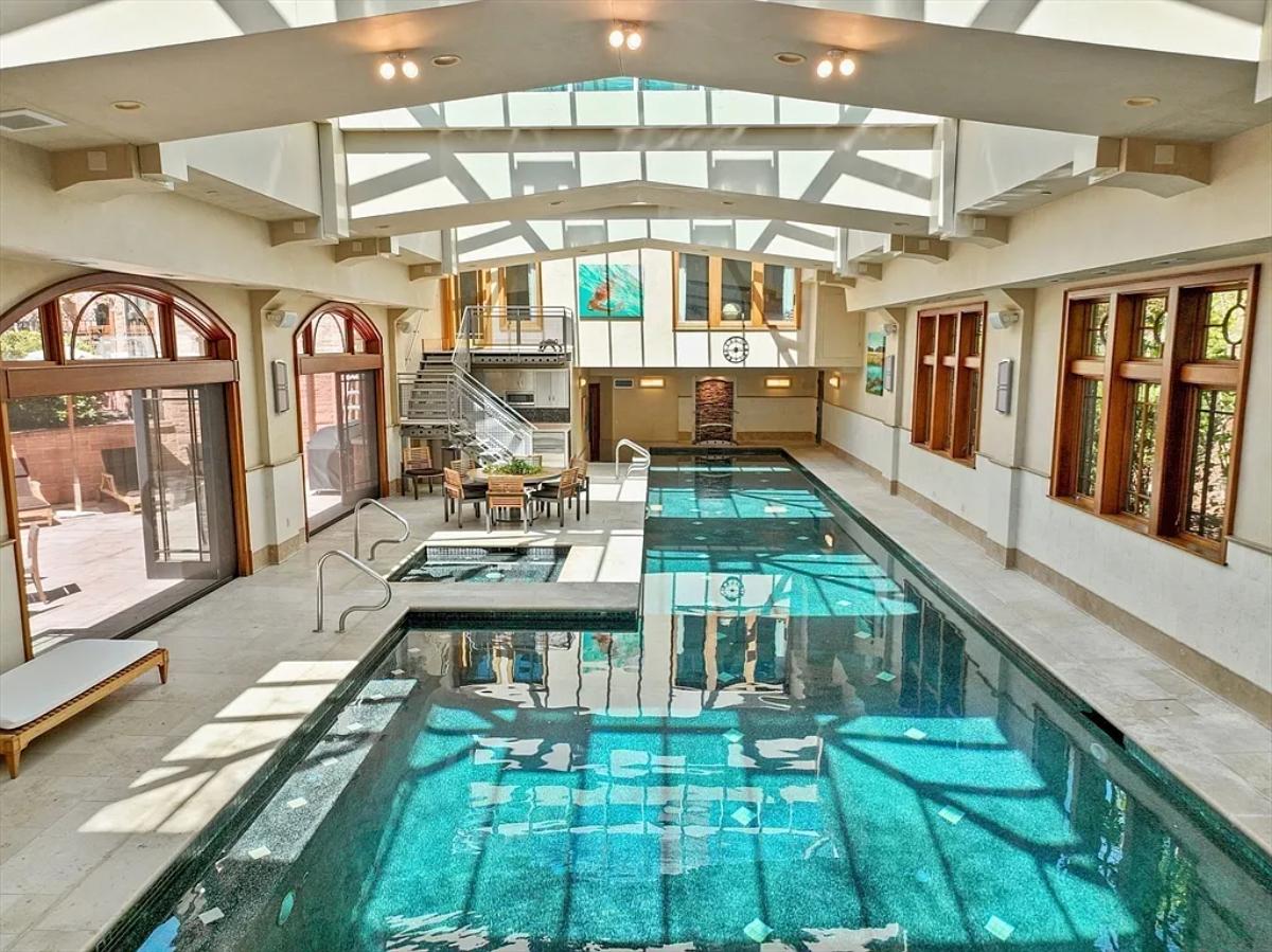 Indoor pool with a dining area.
