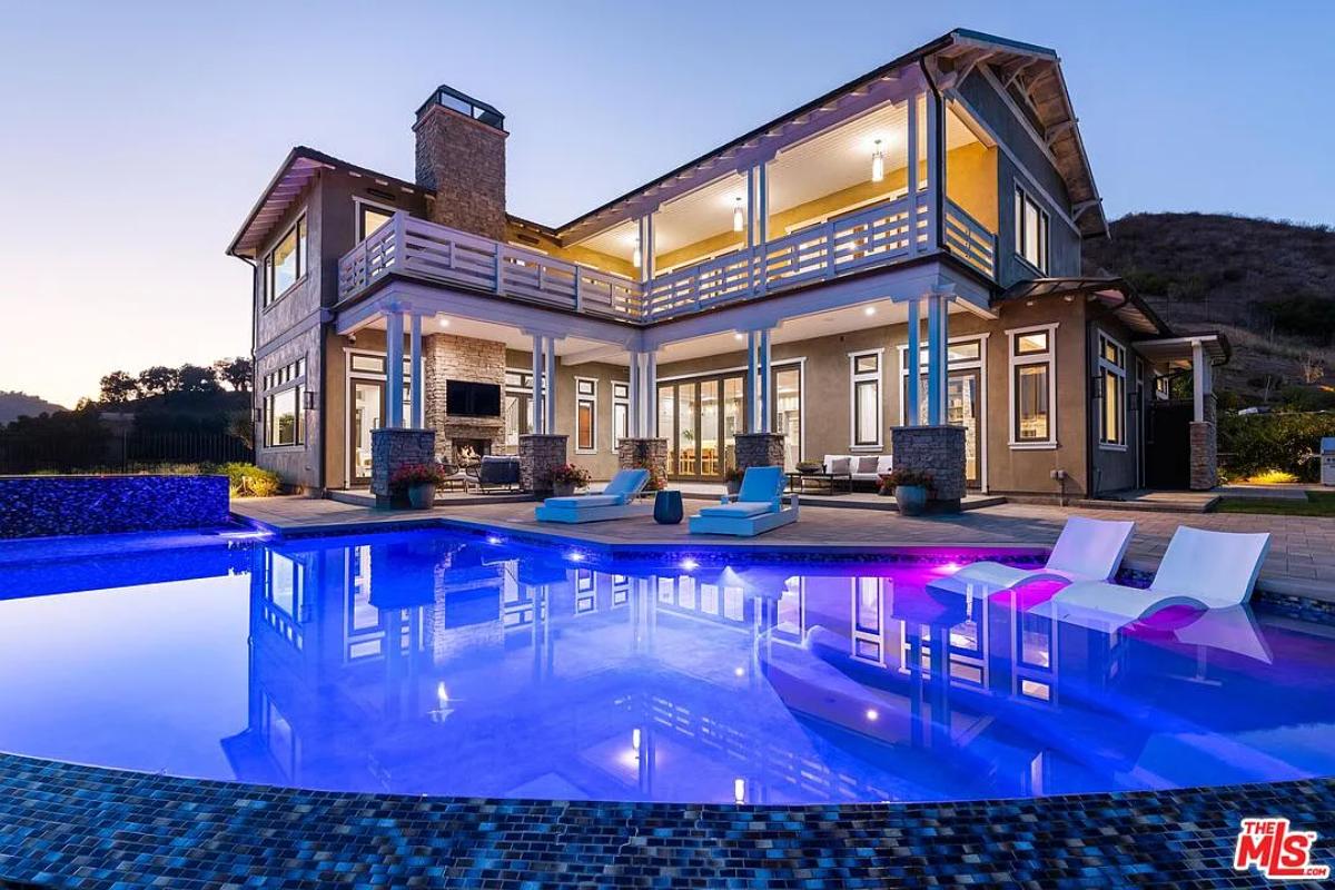 Rear view of the mansion with a pool.
