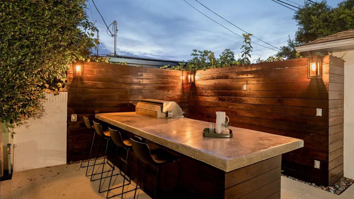 An outdoor bar with chairs and a countertop.