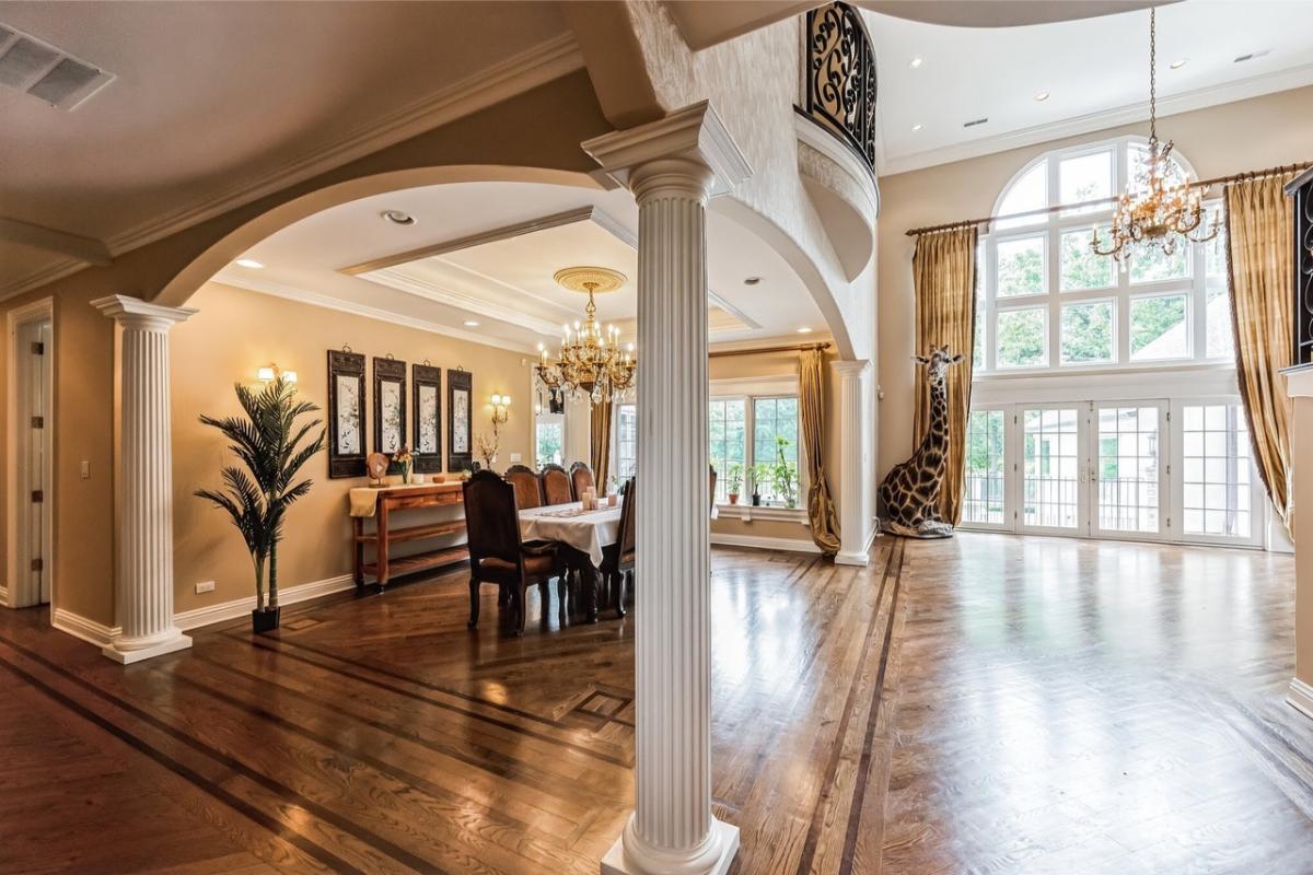 Dining room with a chandelier and hardwood floors.