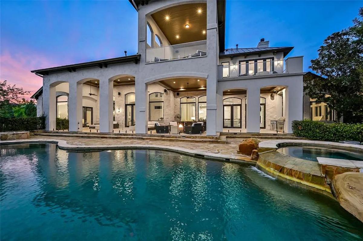 Rear view of the mansion with a pool.