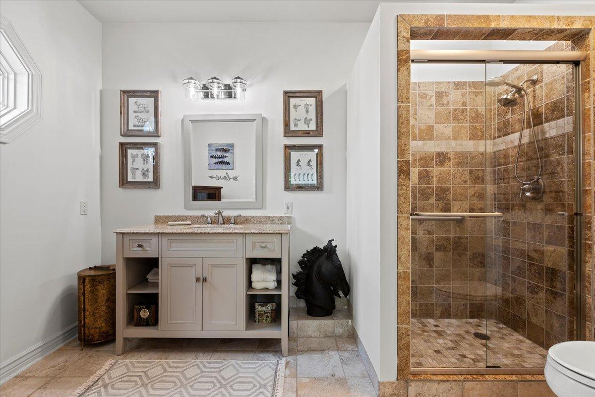 Bathroom with a custom-made vanity and a walk-in shower.