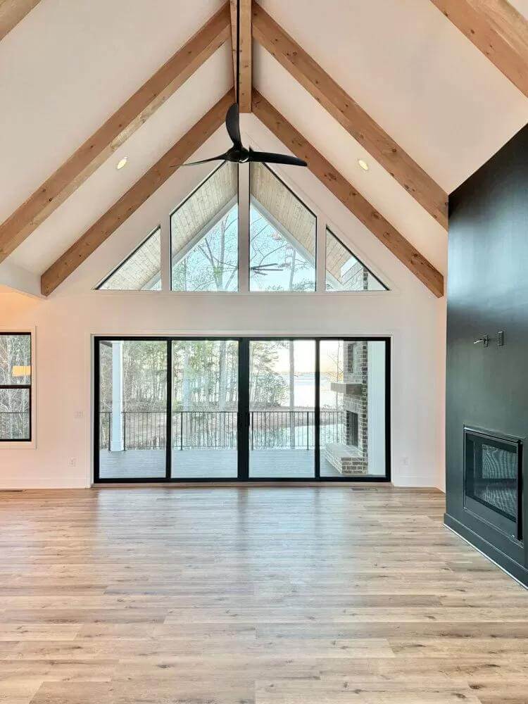 Great room with a fireplace and sliding glass doors that open to the back porch.
