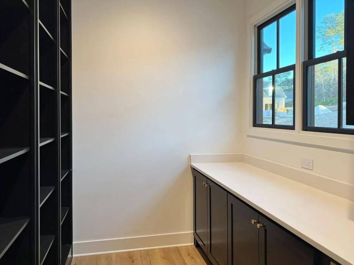 Pantry with built-in cubbies and a quartz countertop.