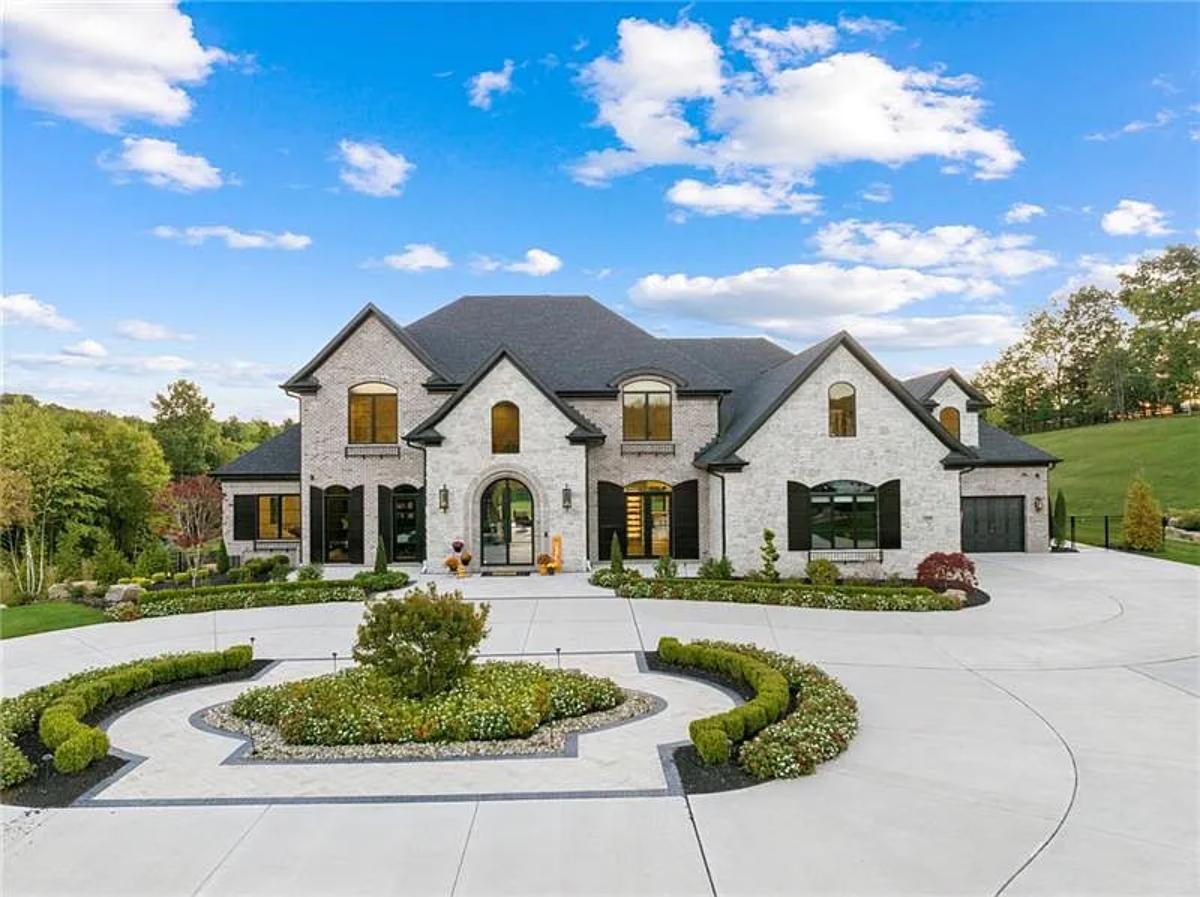 Front view of the mansion with a circular driveway.