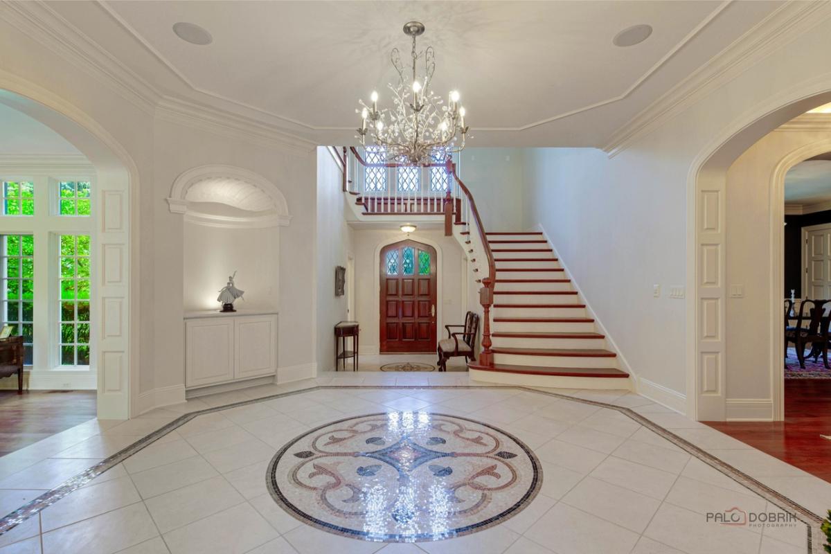 Foyer with a chandelier and stairs.