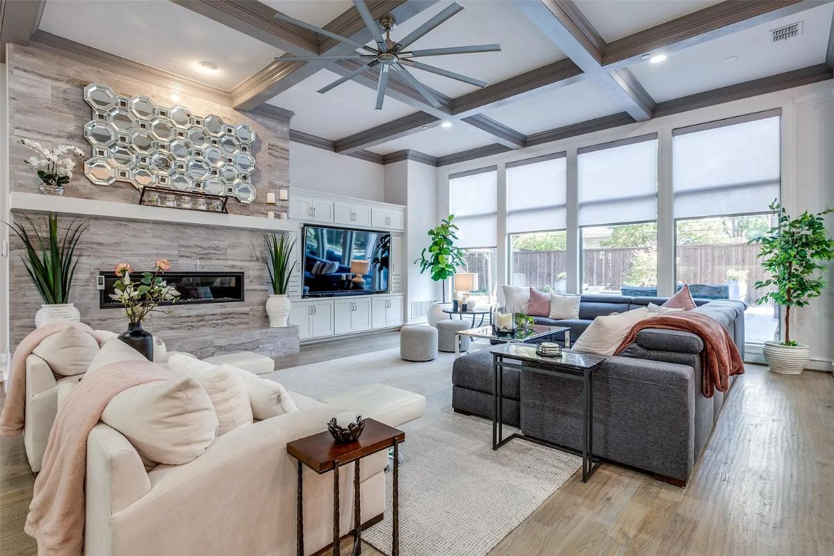 Living room with couches, hardwood floors and a fireplace.