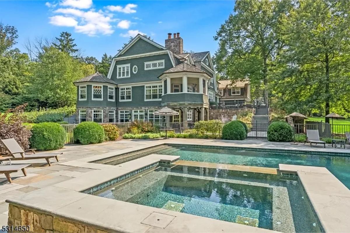 Rear view of the mansion with a pool.