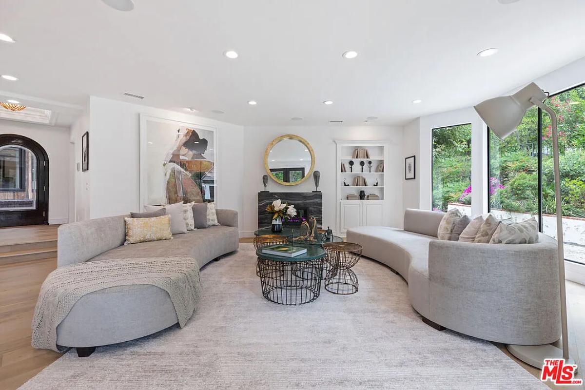 Living room with couches and custom lighting.