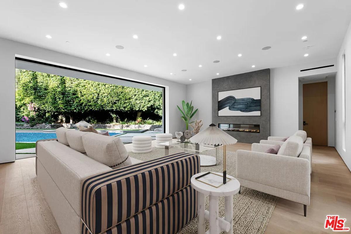 Living room with couches and a fireplace.