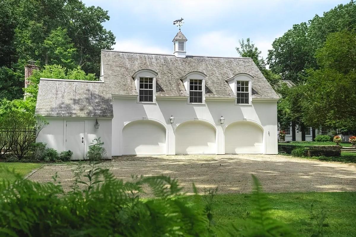 Garage with a spacious driveway.