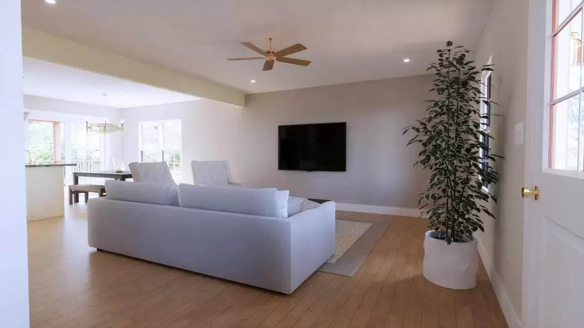 Living room with a gray sofa and a wall-mounted TV.