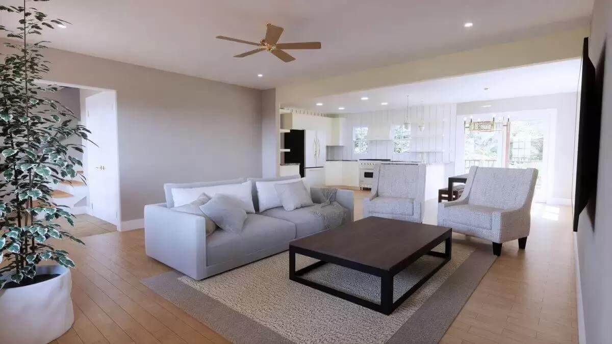 Living room showcasing the sectional sofa, cushioned chairs, and an iron coffee table over the bordered area rug.