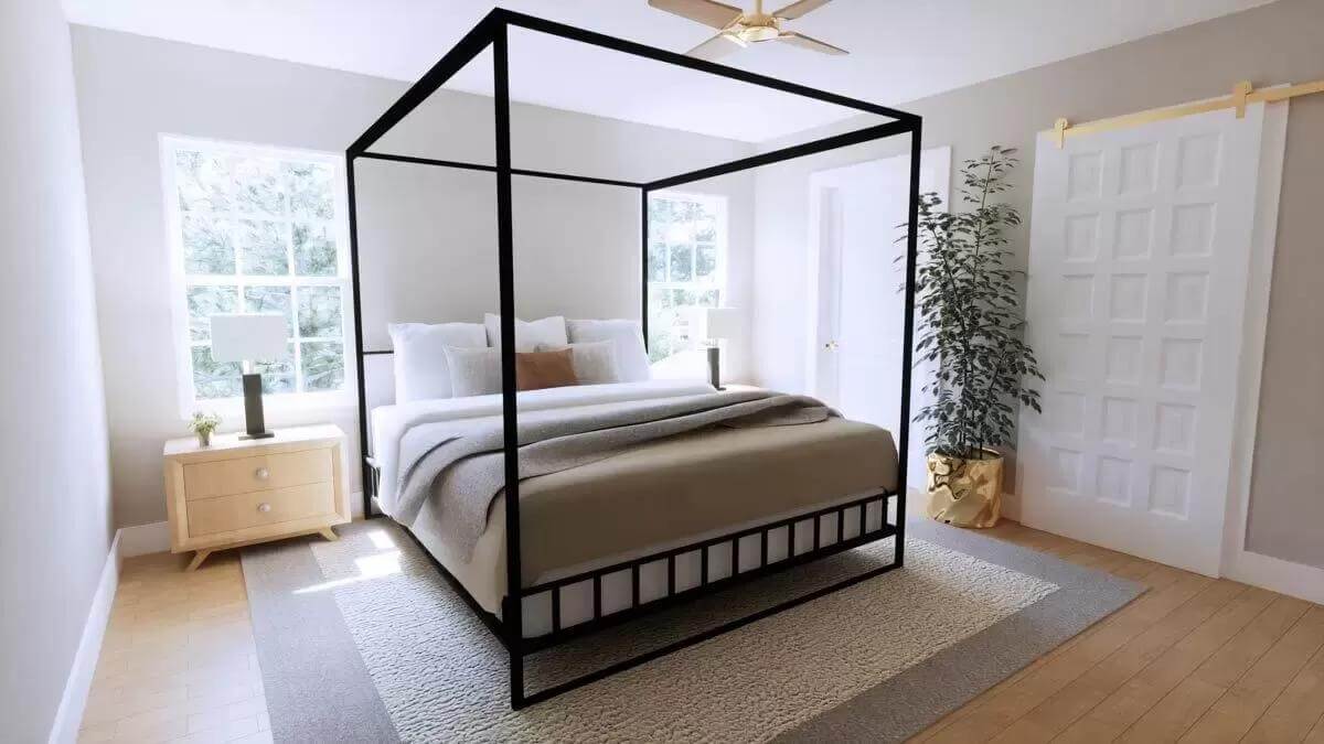 Primary bedroom with a ceiling fan and a canopy bed over the bordered area rug.