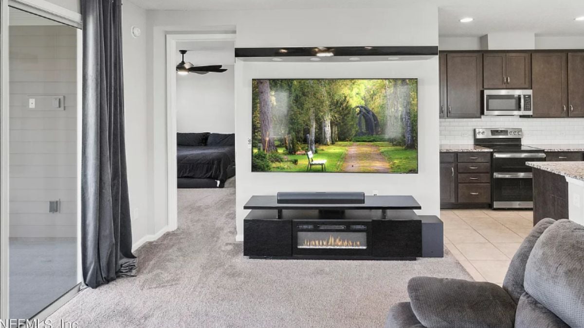 A family room with a TV, a cabinet, and a couch.