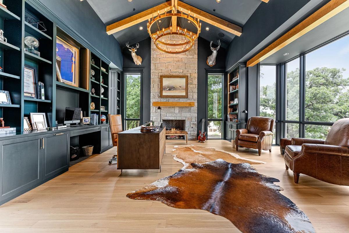 Home office with hardwood floors and glass walls.
