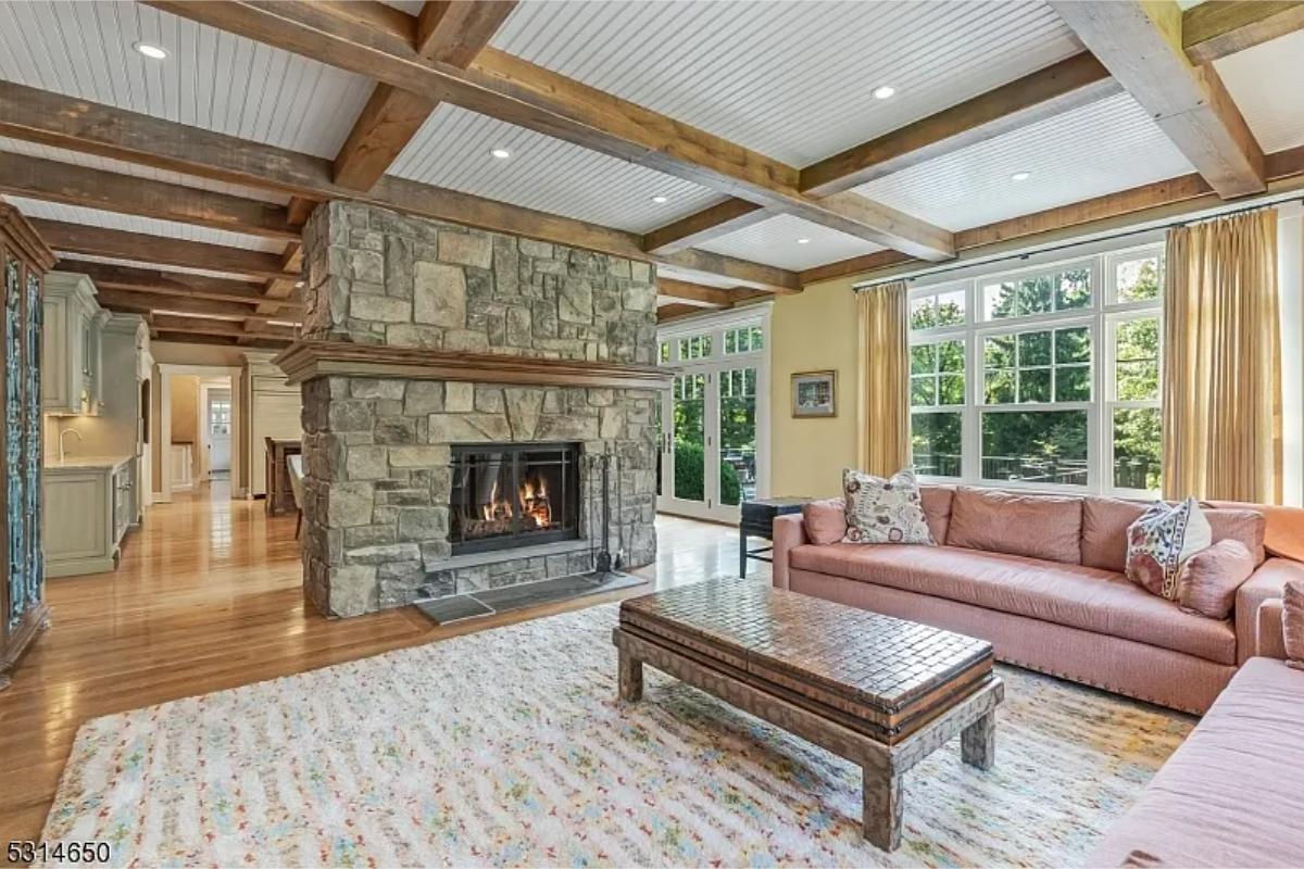 Living room with couches and a fireplace.