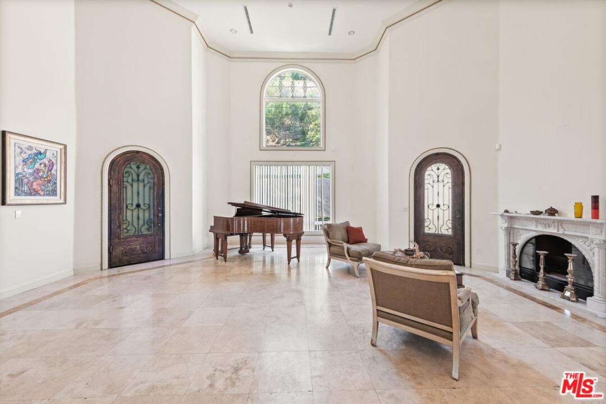 Lounge area with a fireplace and a piano.