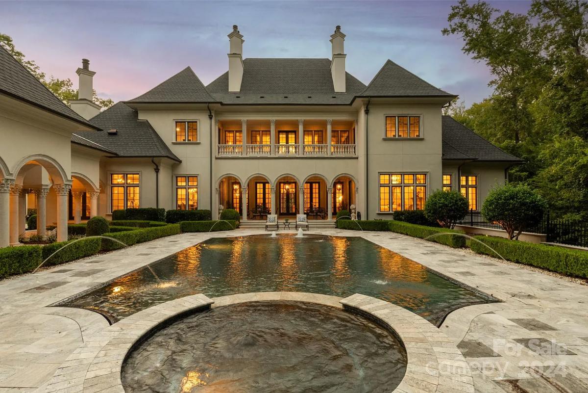 Rear view of the mansion with a pool.