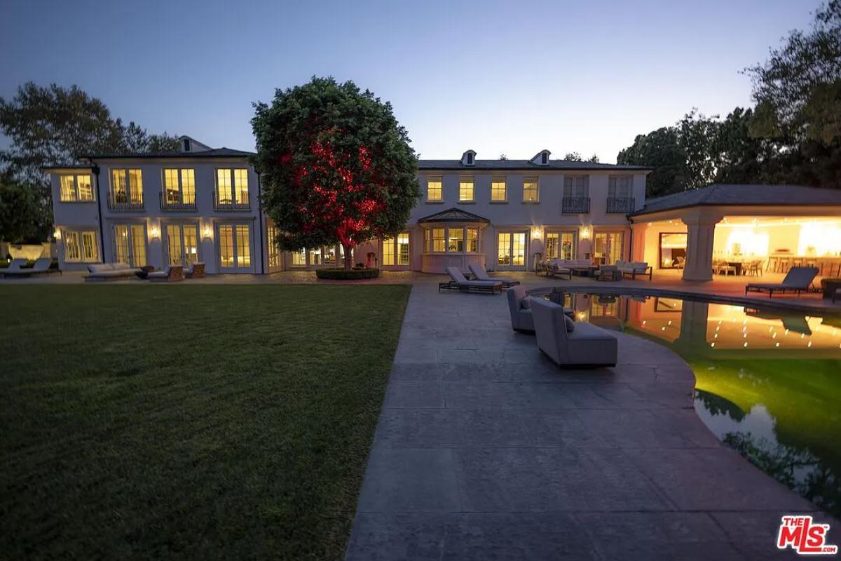 Rear view of the mansion with a pool.