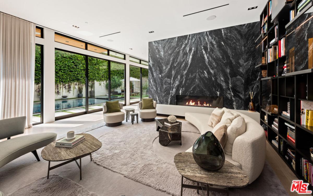 Living room with couches and a fireplace.