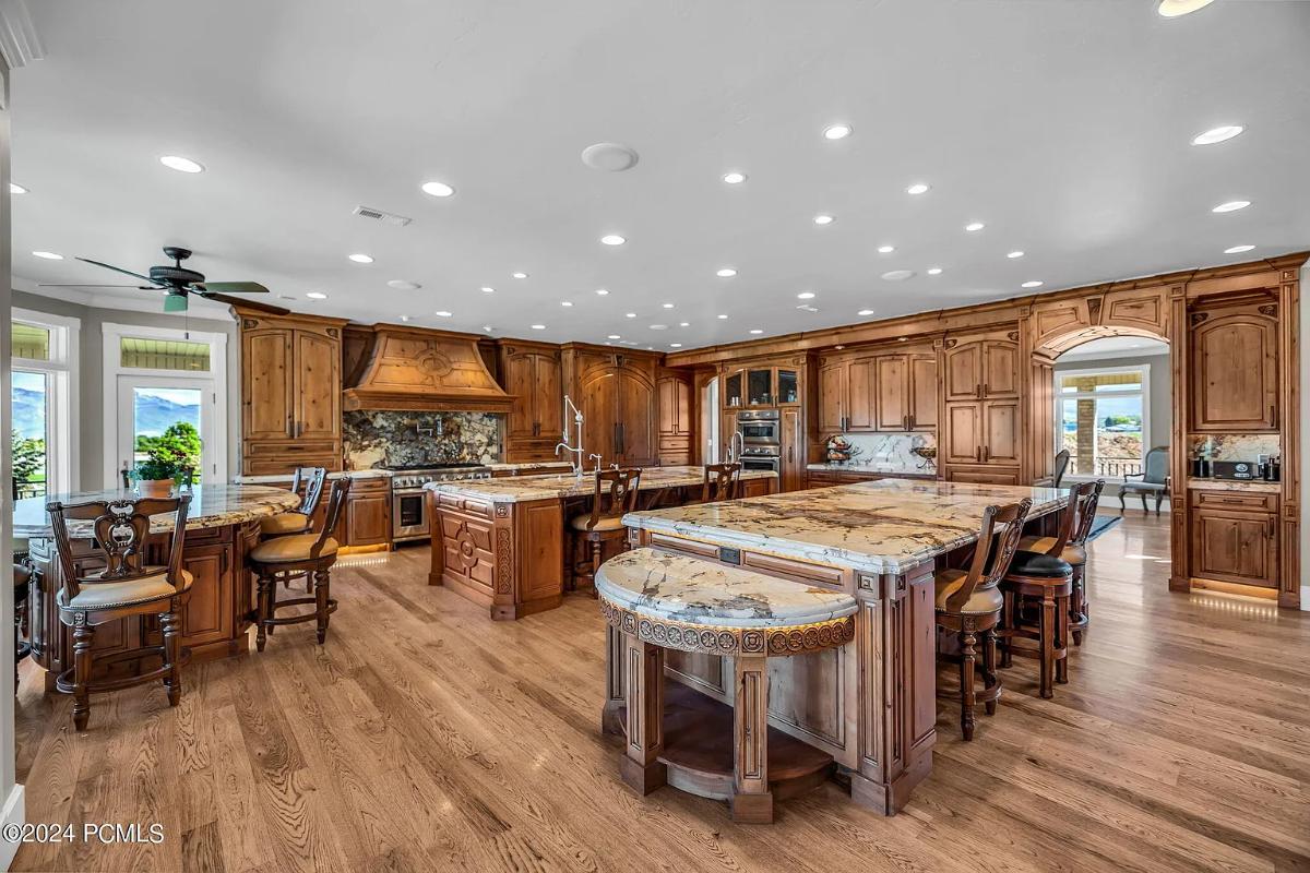 Kitchen with custom cabinetry, a counter breakfast bar and a center island prep area.