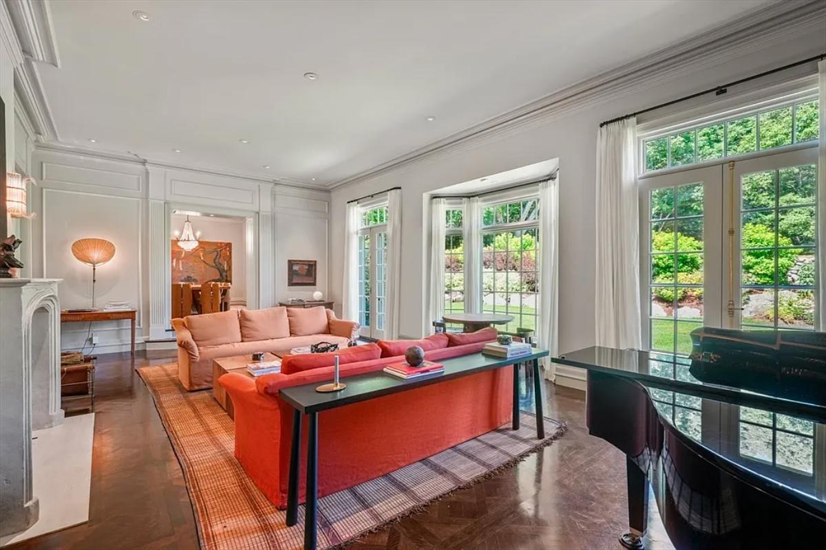 Living room with couches and a fireplace.