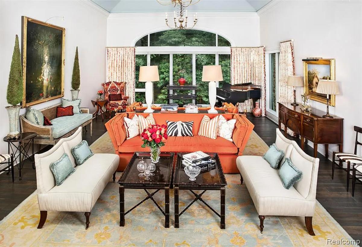 Living room with a piano and hardwood doors.