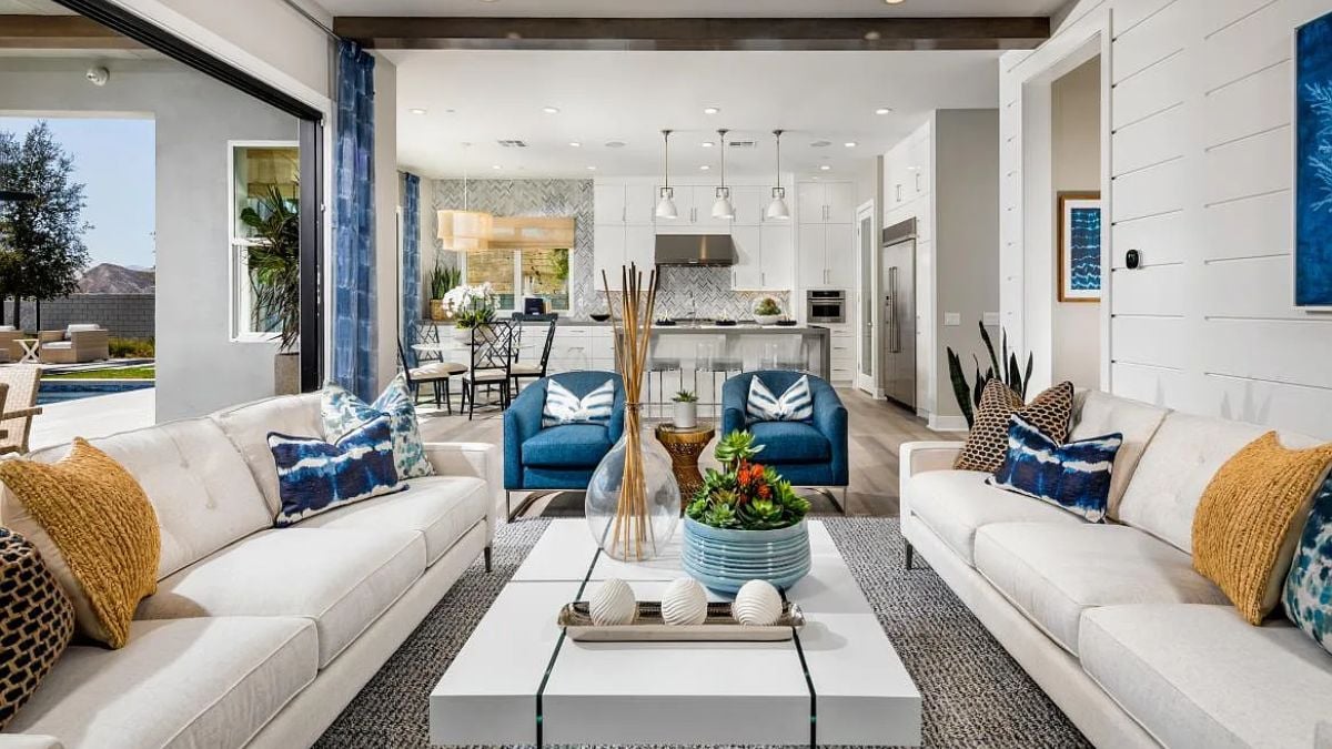 A great room with a living area, dining area, and kitchen.