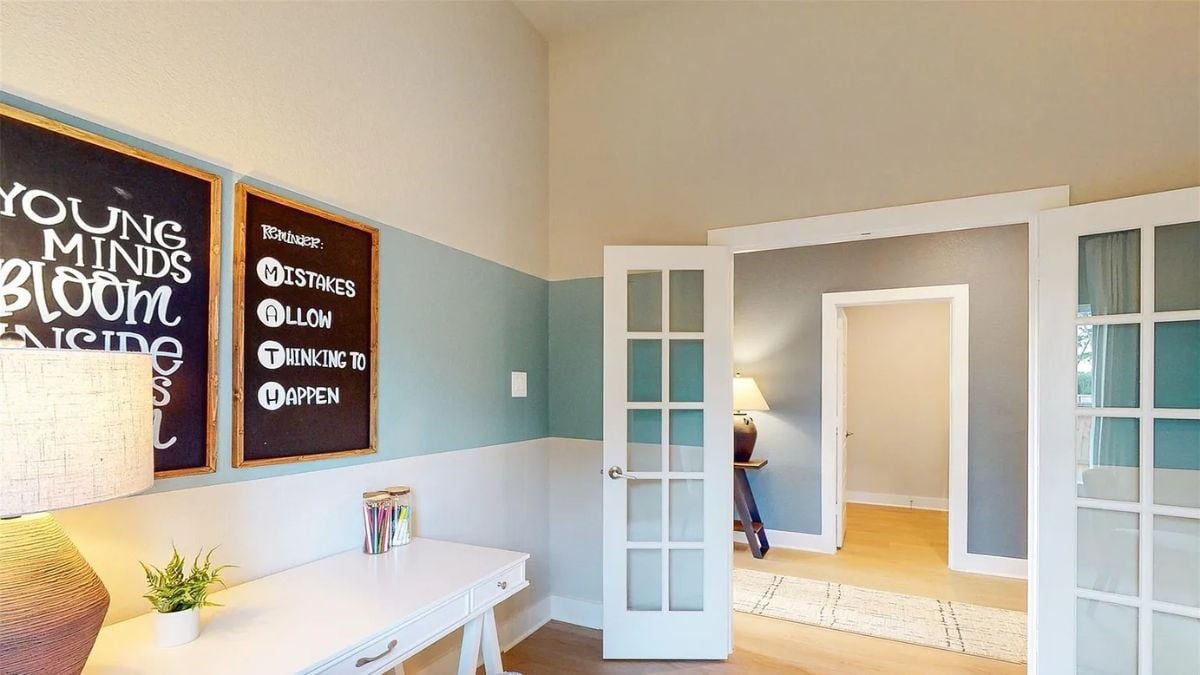 A study room with a desk and a lampshade.