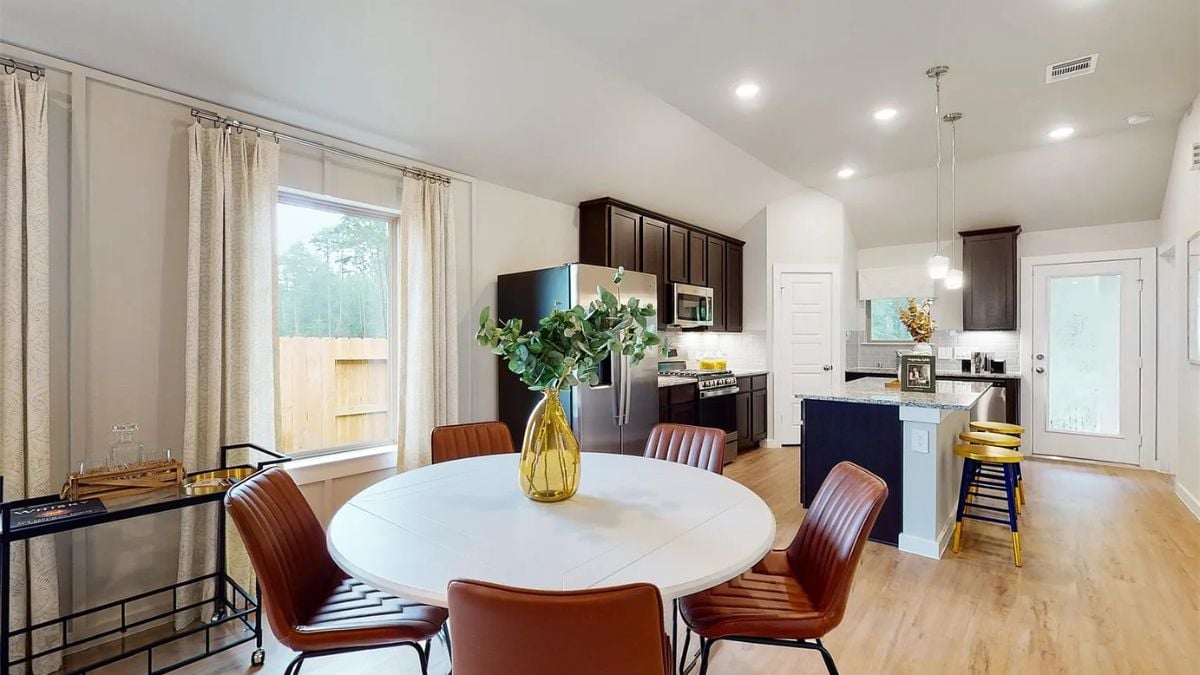 A great room with a dining area and kitchen.
