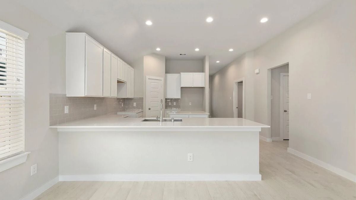 A kitchen with countertops, a sink, and cabinets.