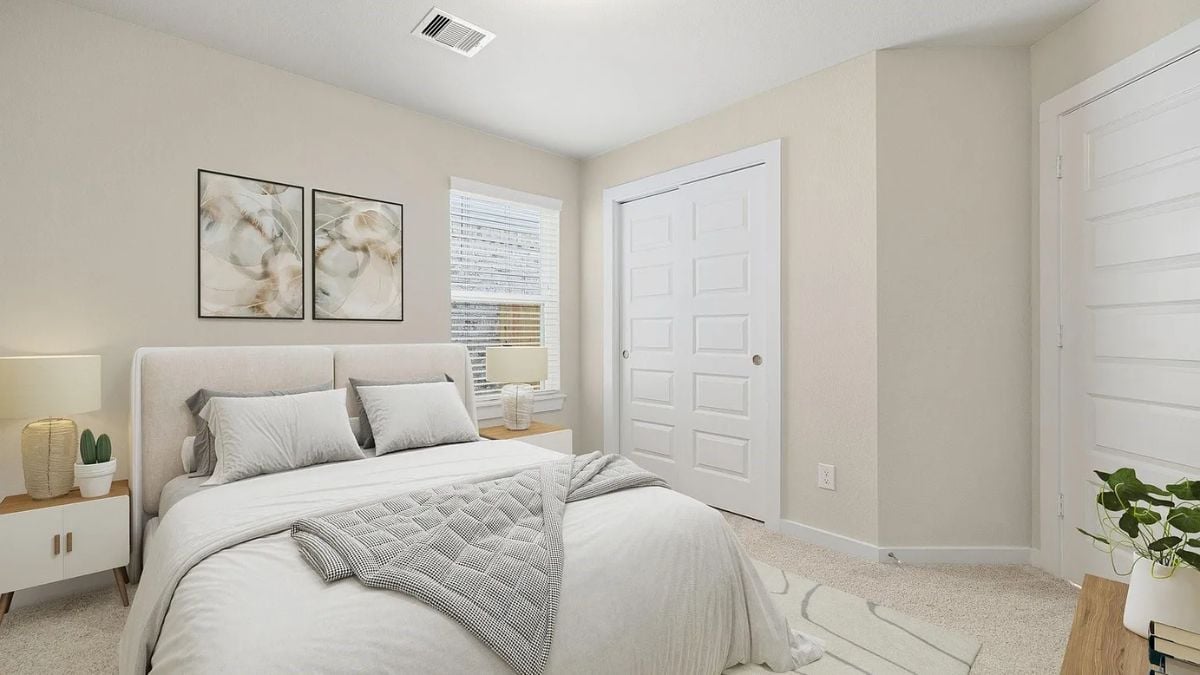 A bedroom with a bed, a window, paintings, and nightstands.