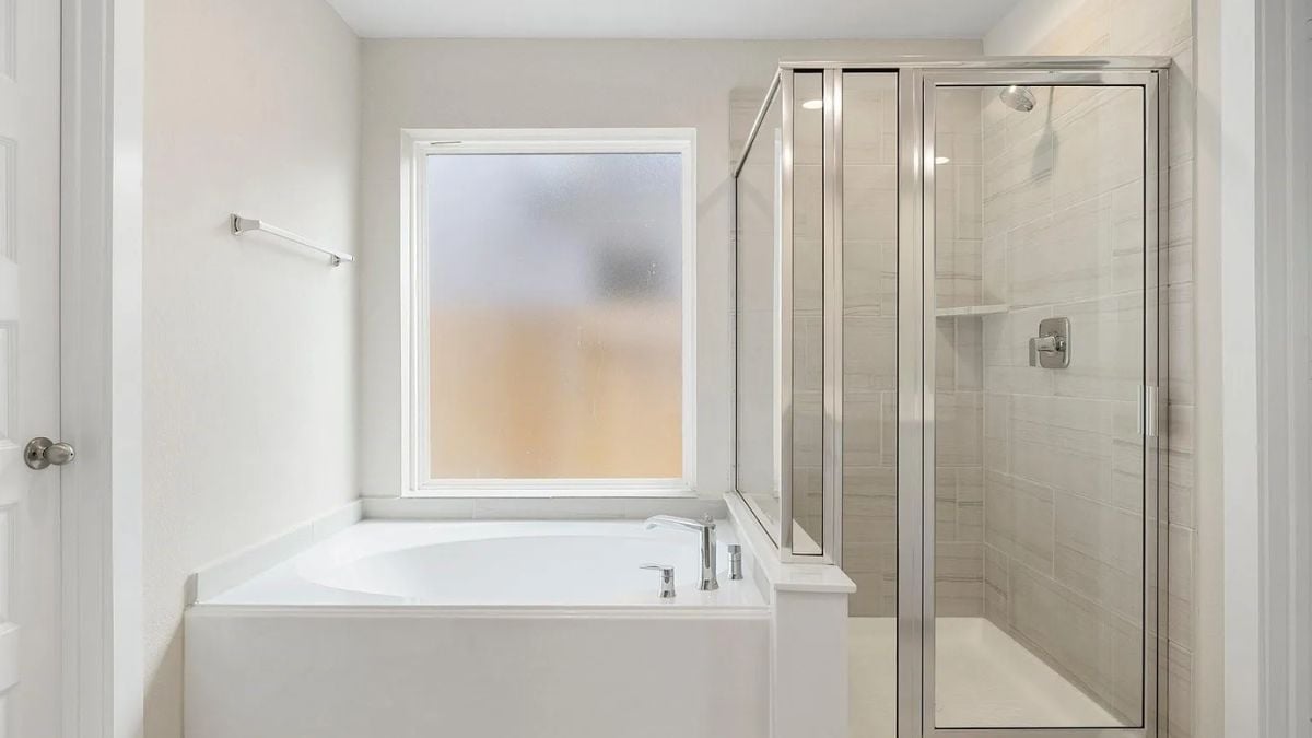 A bathroom with a bathtub and a shower room.