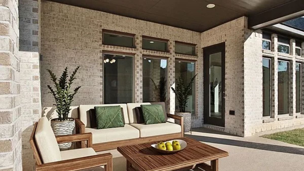 A patio with a couch, a chair, and a center table.