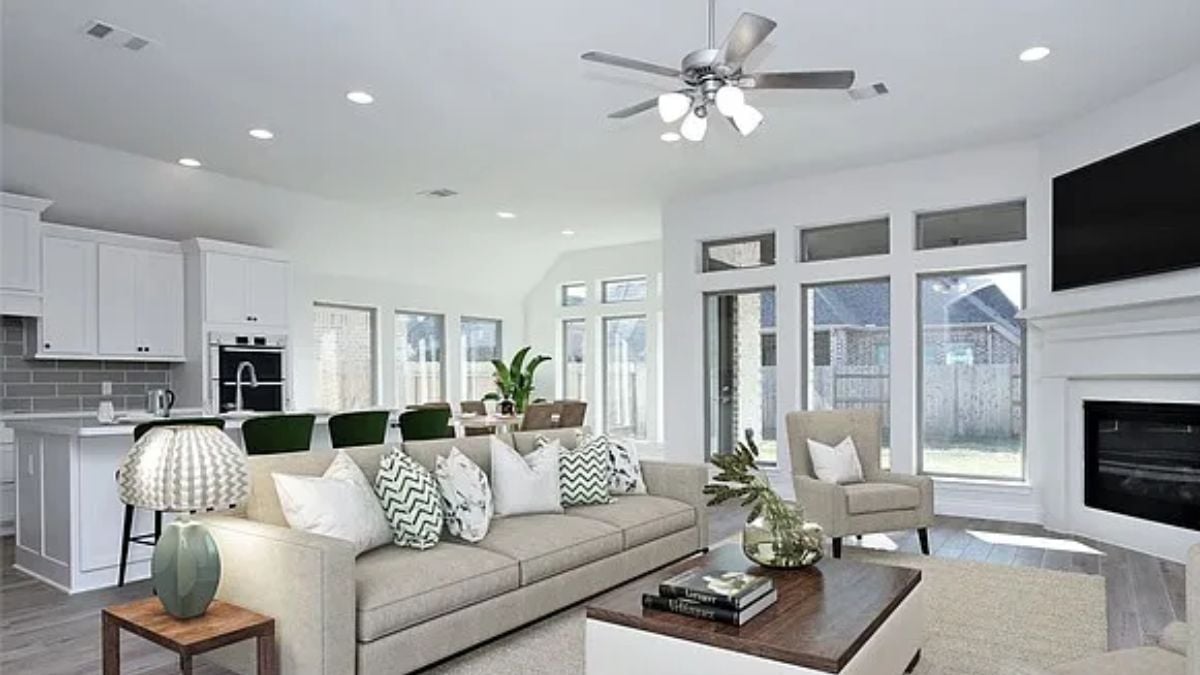 A great room with a dining area, a kitchen, and a living space.
