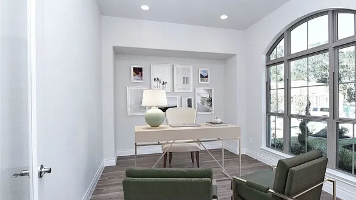 A home office with a window, a desk, and chairs.