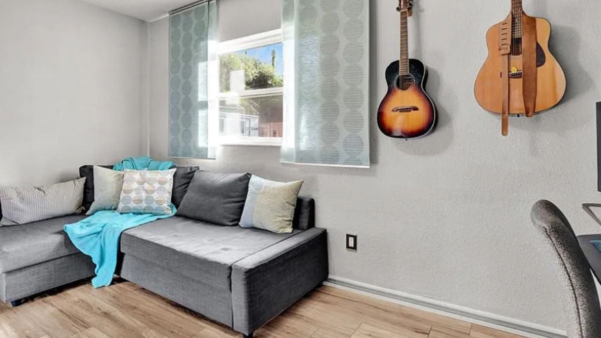 A family room with a window and a couch.