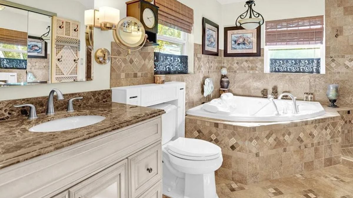 A bathroom with a vanity, a mirror, a bathtub, and a toilet.