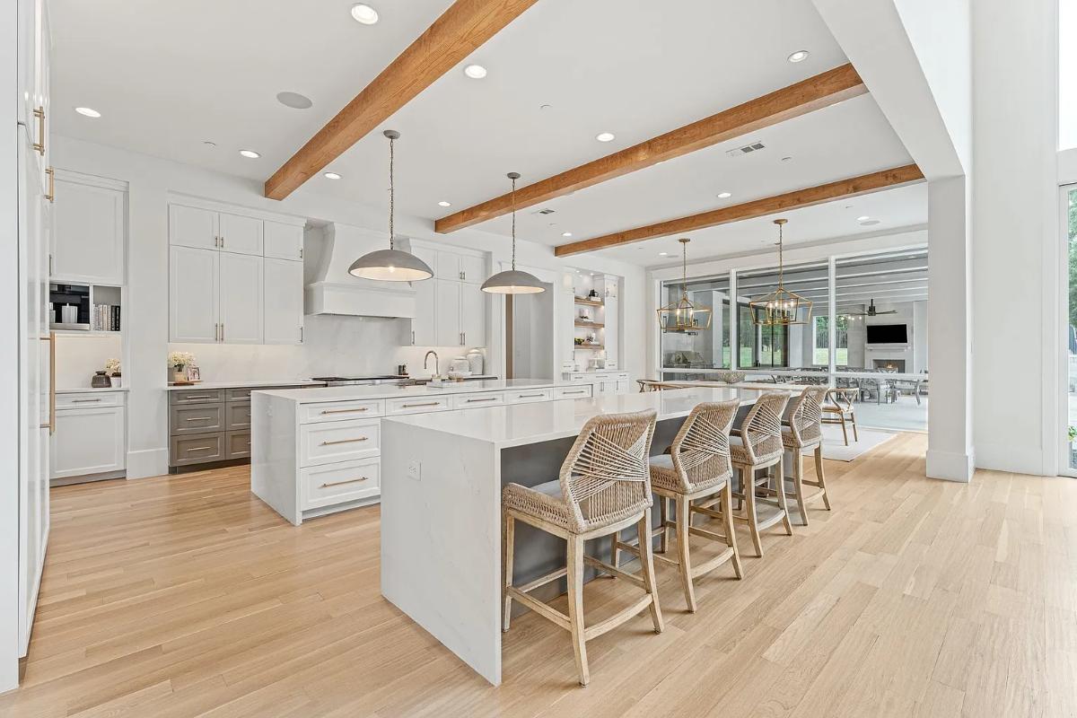 Kitchen with custom cabinetry, a counter breakfast bar and a center island prep area.