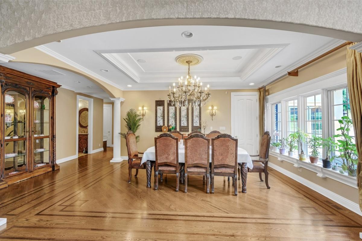 Dining room with a chandelier and hardwood floors.