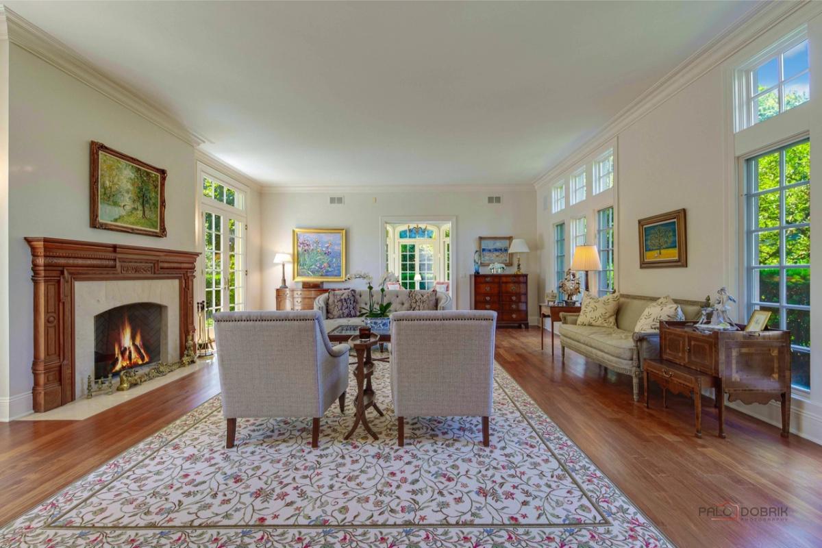 Living room with a fireplace and hardwood floors.