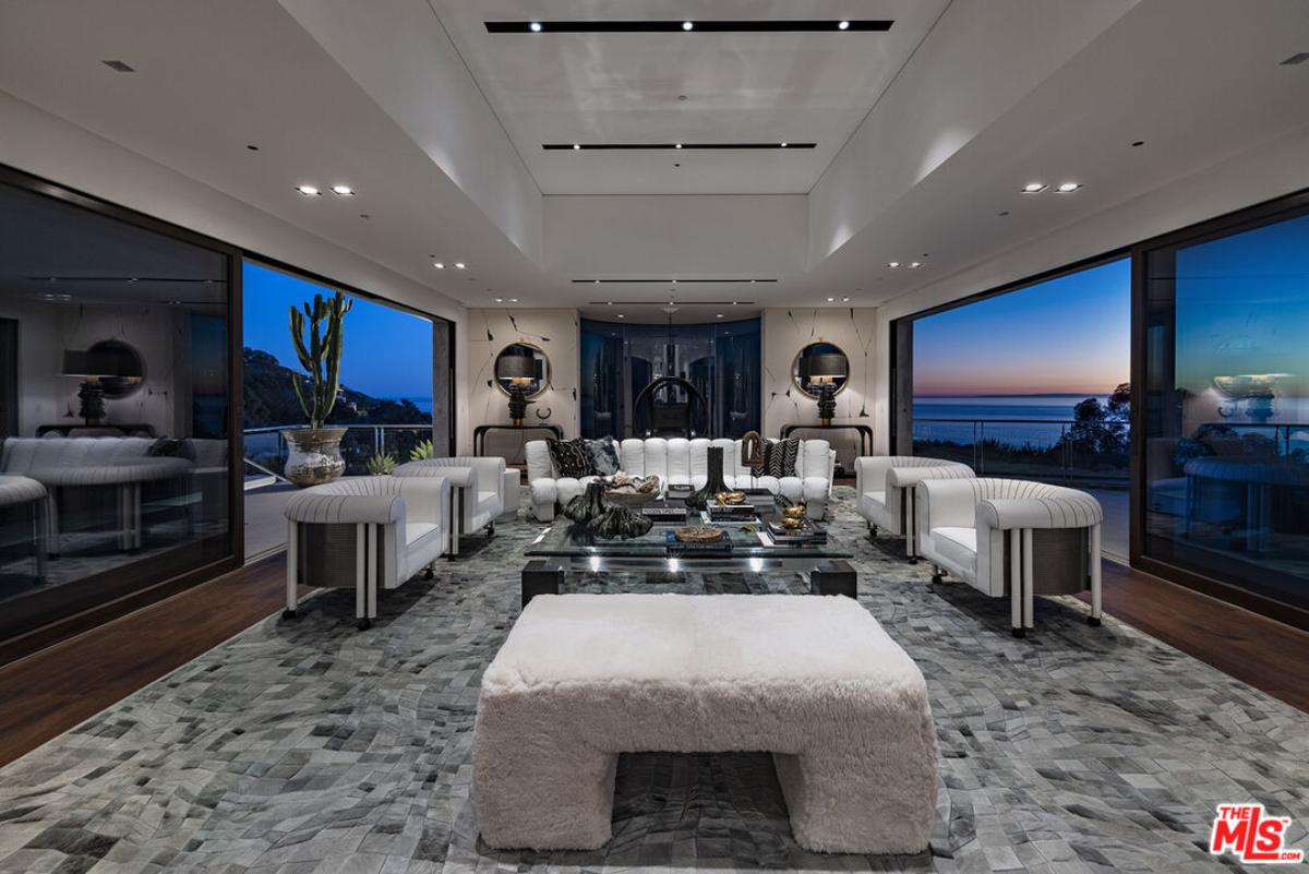 Living room with hardwood floors and sliding glass doors.
