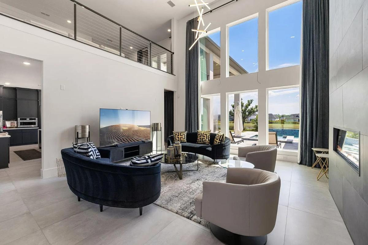 Living room with high ceilings and a fireplace.