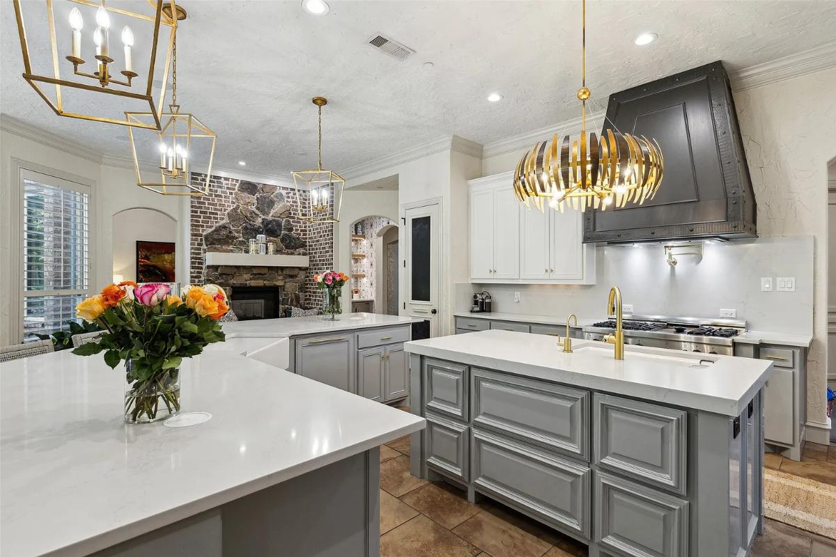 Kitchen with custom cabinetry, a counter breakfast bar and a center island prep area.