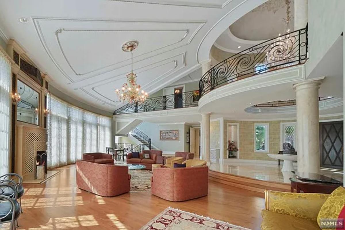 Living room with hardwood flooring and a chandelier.