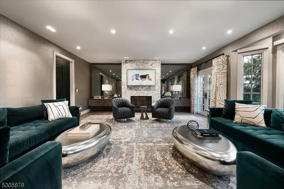 Living room with couches and a fireplace.